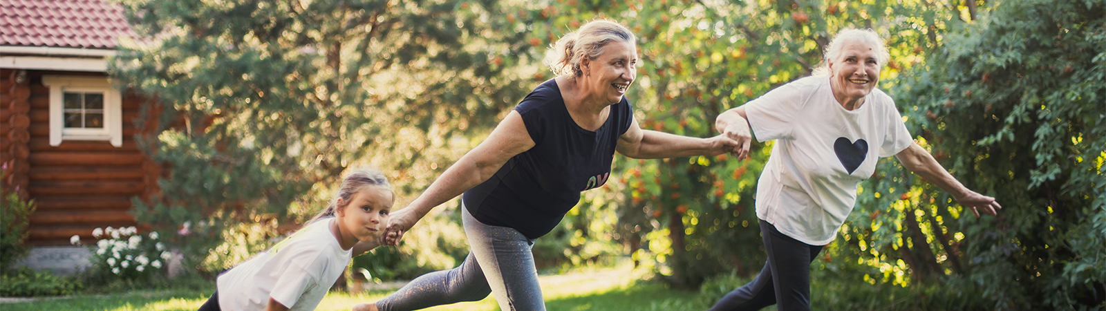 Multi-generational women exercising together outdoors, promoting functional fitness and healthy aging