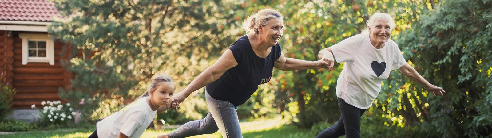 Multi-generational women exercising together outdoors, promoting functional fitness and healthy aging