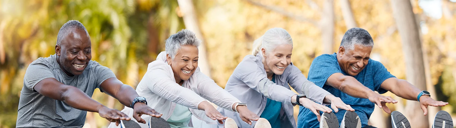 Multiracial senior fitness group stretching in park, promoting healthy aging, mobility and resilience